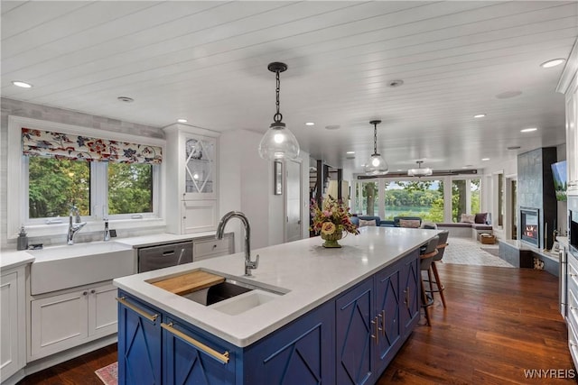 4482 Lower River Rd, Lewiston, NY 14092 - kitchen featuring a sink, open floor plan, dishwasher, blue cabinetry, and recessed lighting