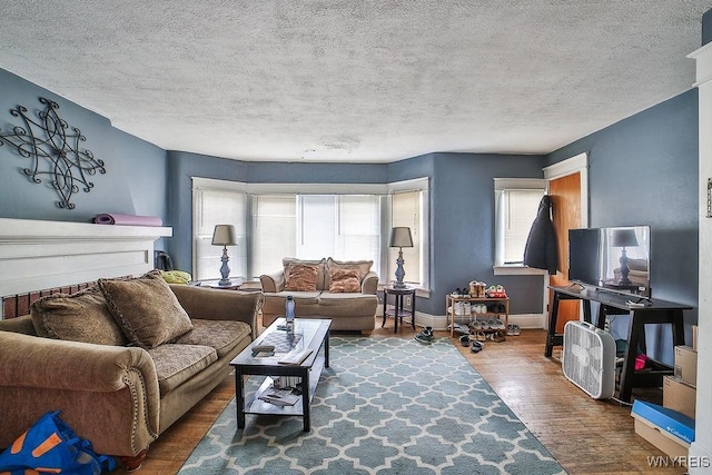 living room with a textured ceiling and wood finished floors