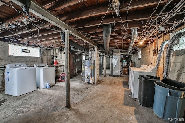 basement featuring water heater and washing machine and clothes dryer