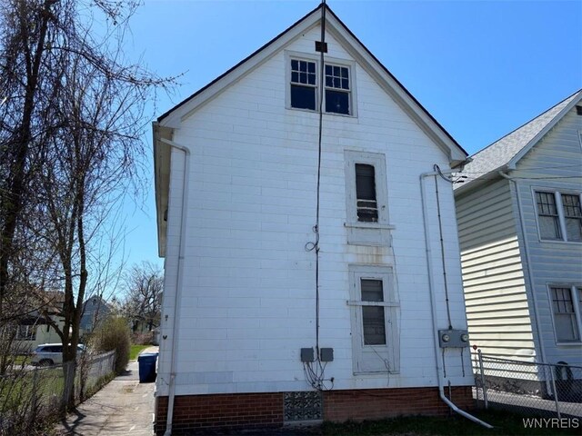 back of property featuring fence