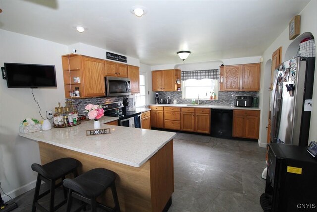 kitchen with open shelves, appliances with stainless steel finishes, a sink, a peninsula, and tasteful backsplash