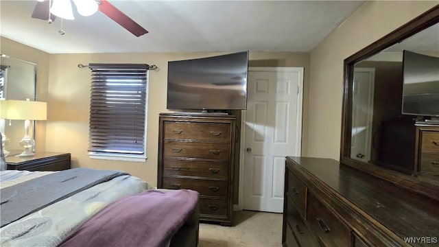 bedroom featuring light carpet and ceiling fan