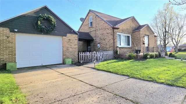 view of front of house with a front lawn, a garage, brick siding, concrete driveway, and fence