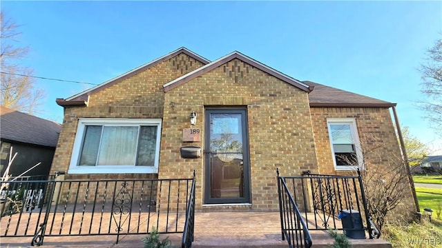 view of front of home with fence and brick siding