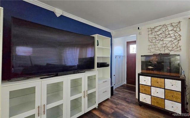 unfurnished living room featuring ornamental molding and dark wood-type flooring