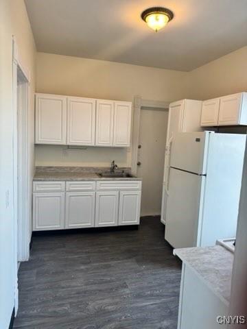 827-29 Burnet Ave Unit 29, Syracuse, NY 13203 - kitchen featuring freestanding refrigerator, light countertops, white cabinets, a sink, and dark wood-type flooring