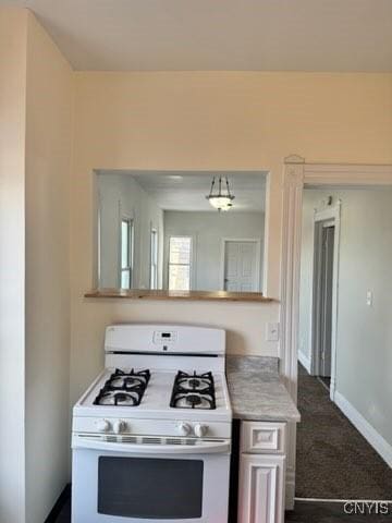 827-29 Burnet Ave Unit 29, Syracuse, NY 13203 - kitchen with dark carpet, white gas range oven, light countertops, and baseboards
