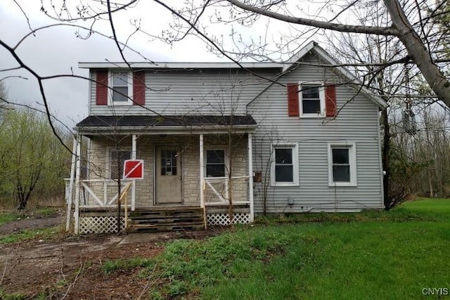 24 Railroad St, Elbridge, NY 13080 - traditional home featuring covered porch and a front lawn