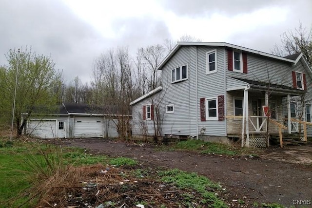 24 Railroad St, Elbridge, NY 13080 - exterior space featuring covered porch, an outbuilding, and a garage