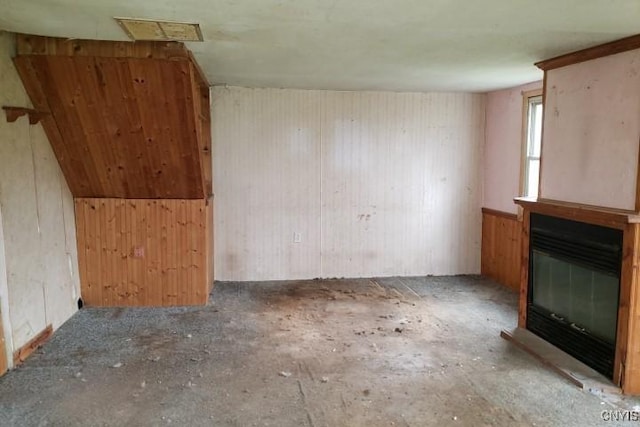 24 Railroad St, Elbridge, NY 13080 - unfurnished living room with wood walls and a glass covered fireplace