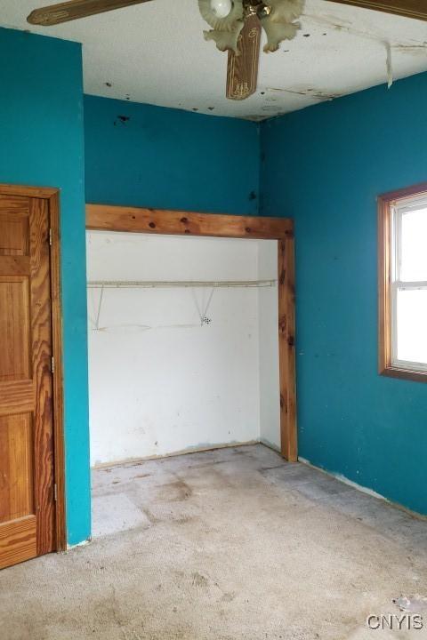 24 Railroad St, Elbridge, NY 13080 - unfurnished bedroom featuring ceiling fan and carpet