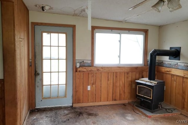 24 Railroad St, Elbridge, NY 13080 - interior space featuring a healthy amount of sunlight, a wainscoted wall, and a wood stove