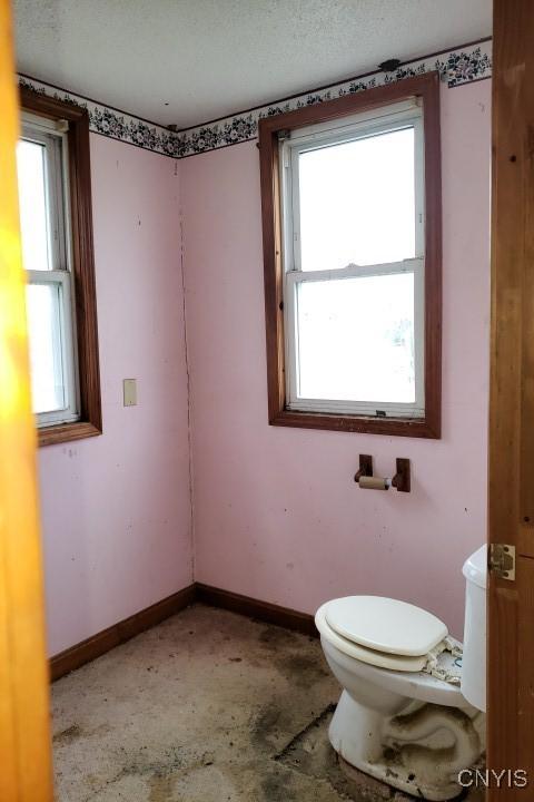 24 Railroad St, Elbridge, NY 13080 - half bath with baseboards, a healthy amount of sunlight, and toilet