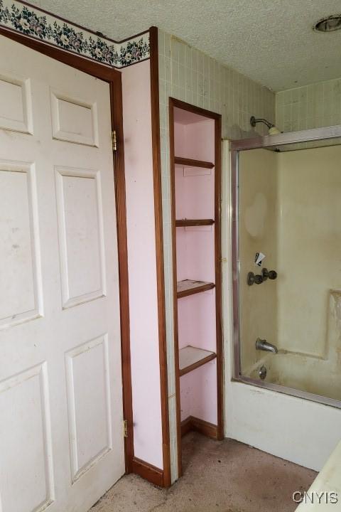 24 Railroad St, Elbridge, NY 13080 - full bath featuring baseboards, a textured ceiling, and tub / shower combination