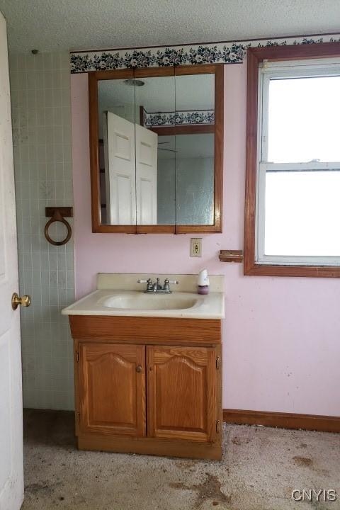 24 Railroad St, Elbridge, NY 13080 - bathroom with a textured ceiling and vanity
