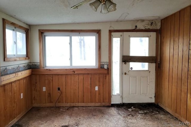 24 Railroad St, Elbridge, NY 13080 - interior space featuring wooden walls, a wainscoted wall, and a textured ceiling