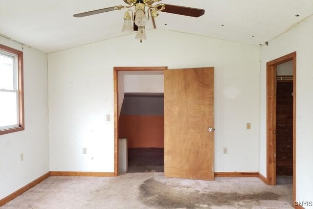 24 Railroad St, Elbridge, NY 13080 - unfurnished bedroom with a closet, a ceiling fan, a walk in closet, baseboards, and lofted ceiling