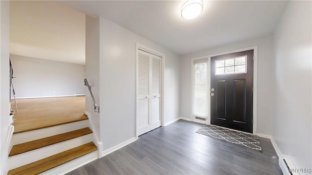 entryway featuring baseboards, wood finished floors, and a baseboard heating unit