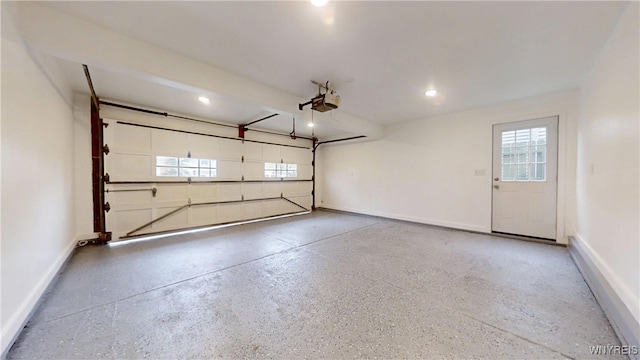 garage with recessed lighting, a garage door opener, and baseboards