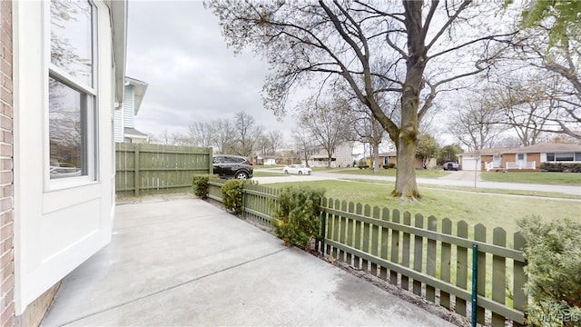 view of patio with fence and a residential view