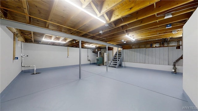 basement with stairway and water heater