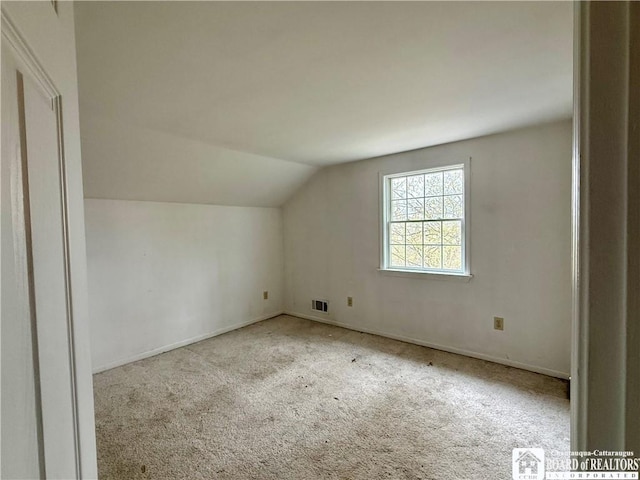 bonus room featuring visible vents, carpet flooring, lofted ceiling, and baseboards