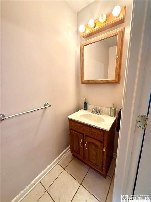 bathroom with vanity, tile patterned floors, and baseboards