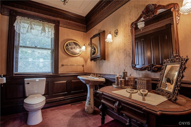 bathroom featuring visible vents, toilet, a wainscoted wall, and ornamental molding