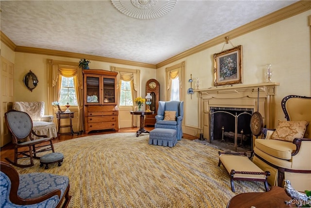 living room featuring a fireplace with flush hearth, a textured ceiling, wood finished floors, and ornamental molding