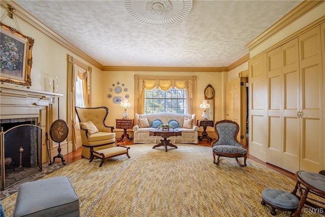 sitting room featuring wood finished floors, a textured ceiling, a fireplace with flush hearth, and crown molding