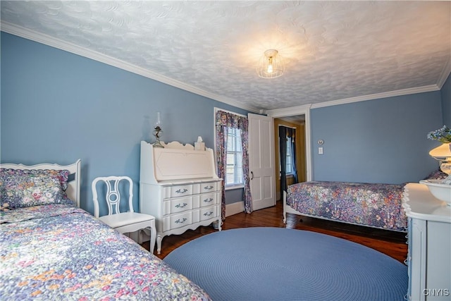 bedroom with ornamental molding and wood finished floors