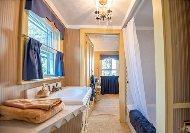 bathroom featuring ornamental molding, vanity, shower / bath combo with shower curtain, and a chandelier