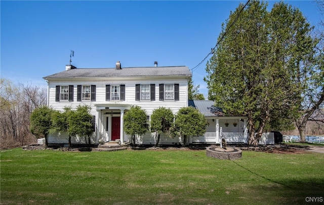 colonial home with a porch and a front lawn