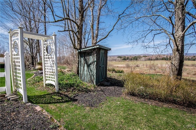 view of yard featuring a shed and an outbuilding