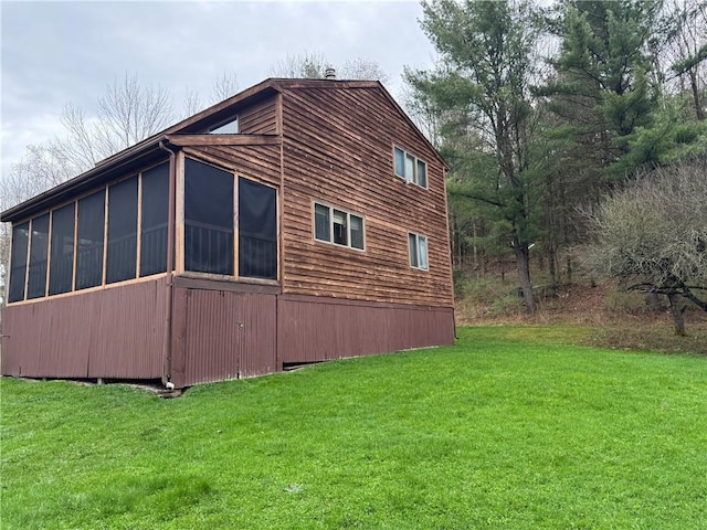view of property exterior featuring a yard and a sunroom