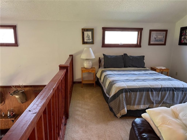 bedroom with a textured ceiling and light carpet