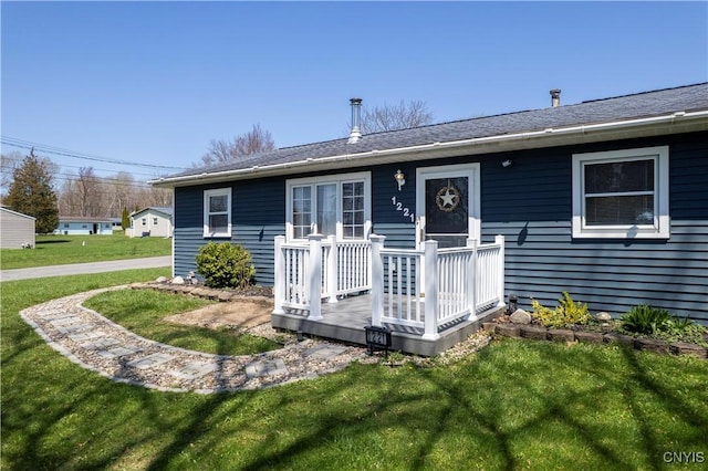 rear view of property with a lawn
