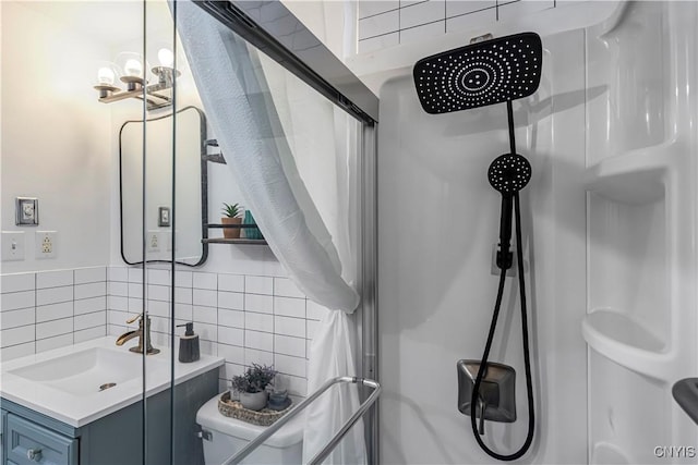 full bath with tasteful backsplash, a shower, toilet, tile walls, and vanity