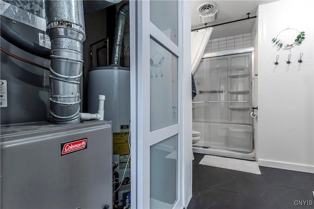 utility room featuring visible vents, heating unit, and gas water heater