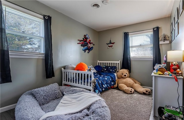 bedroom featuring visible vents and baseboards