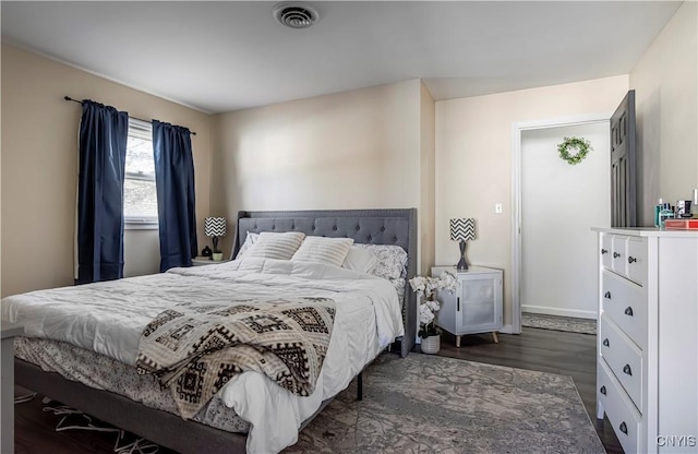 bedroom featuring visible vents, wood finished floors, and baseboards