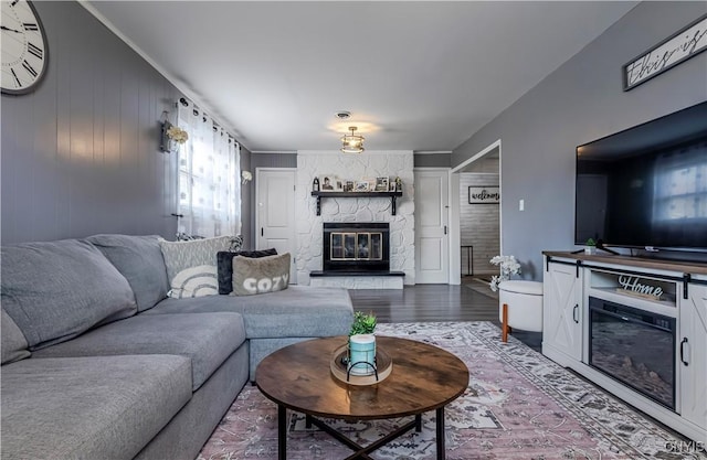 living area with wood finished floors and a fireplace