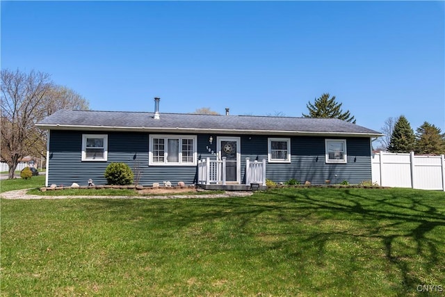single story home featuring fence and a front lawn