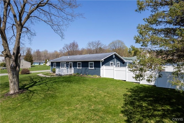 single story home with a front yard and fence