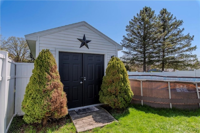view of shed featuring fence