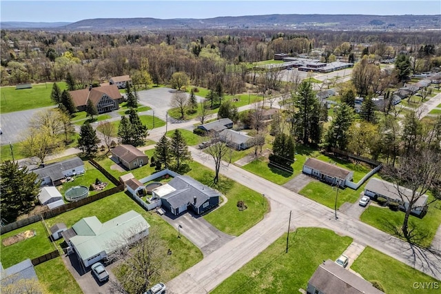 drone / aerial view featuring a view of trees and a residential view