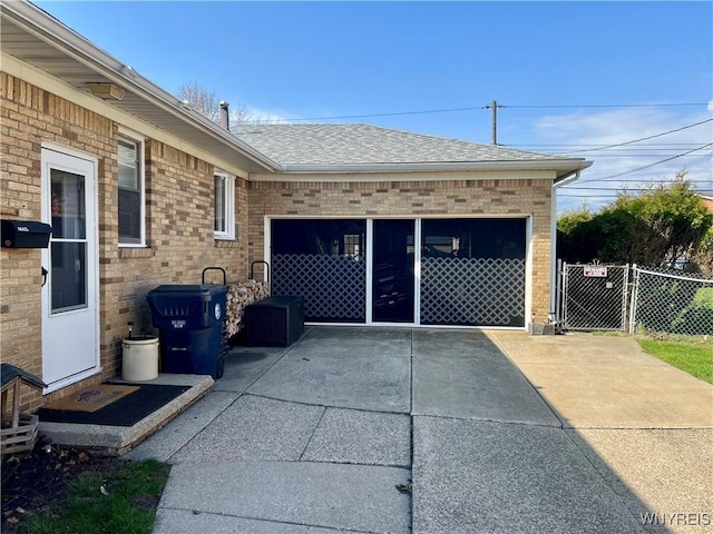 garage with a gate and fence