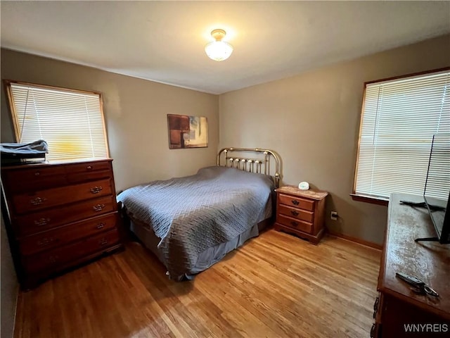 bedroom featuring baseboards and light wood-style floors