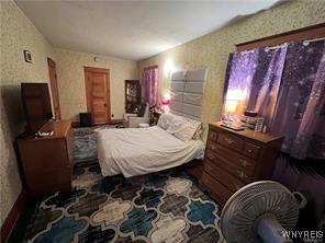 bedroom featuring wallpapered walls