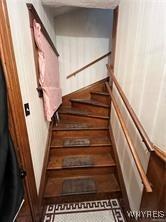 stairway featuring baseboards